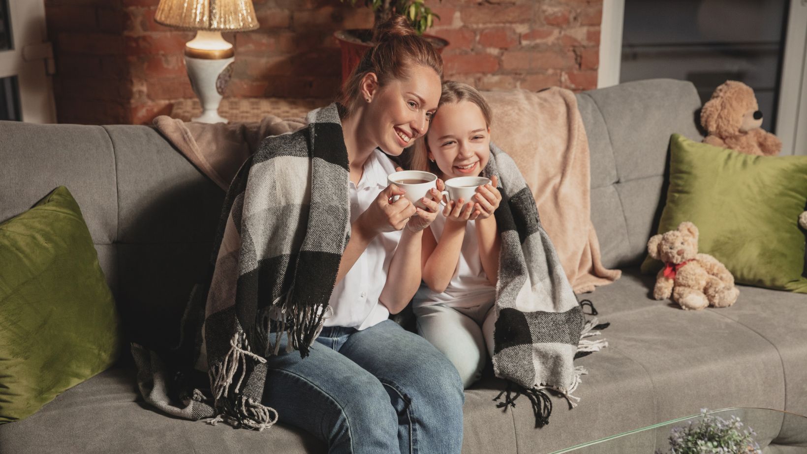 mother and daughter cozy on the couch together